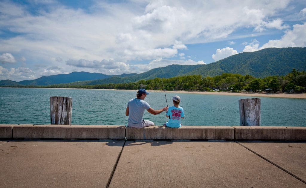Father and son fishing on Palm Cove jetty