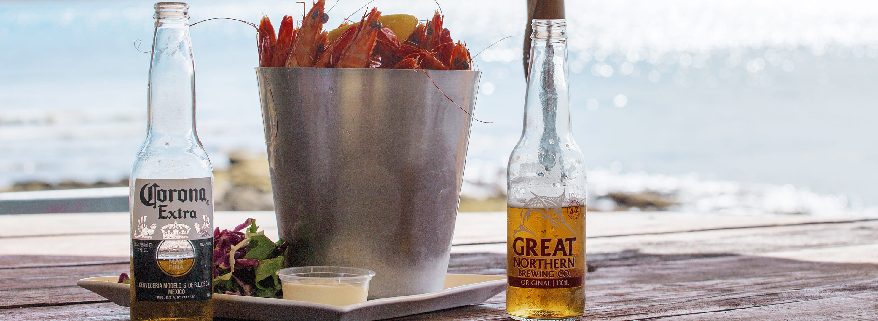 Beer and prawns beside the beach