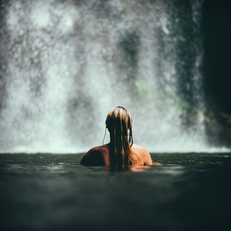 Swimming in front of waterfall